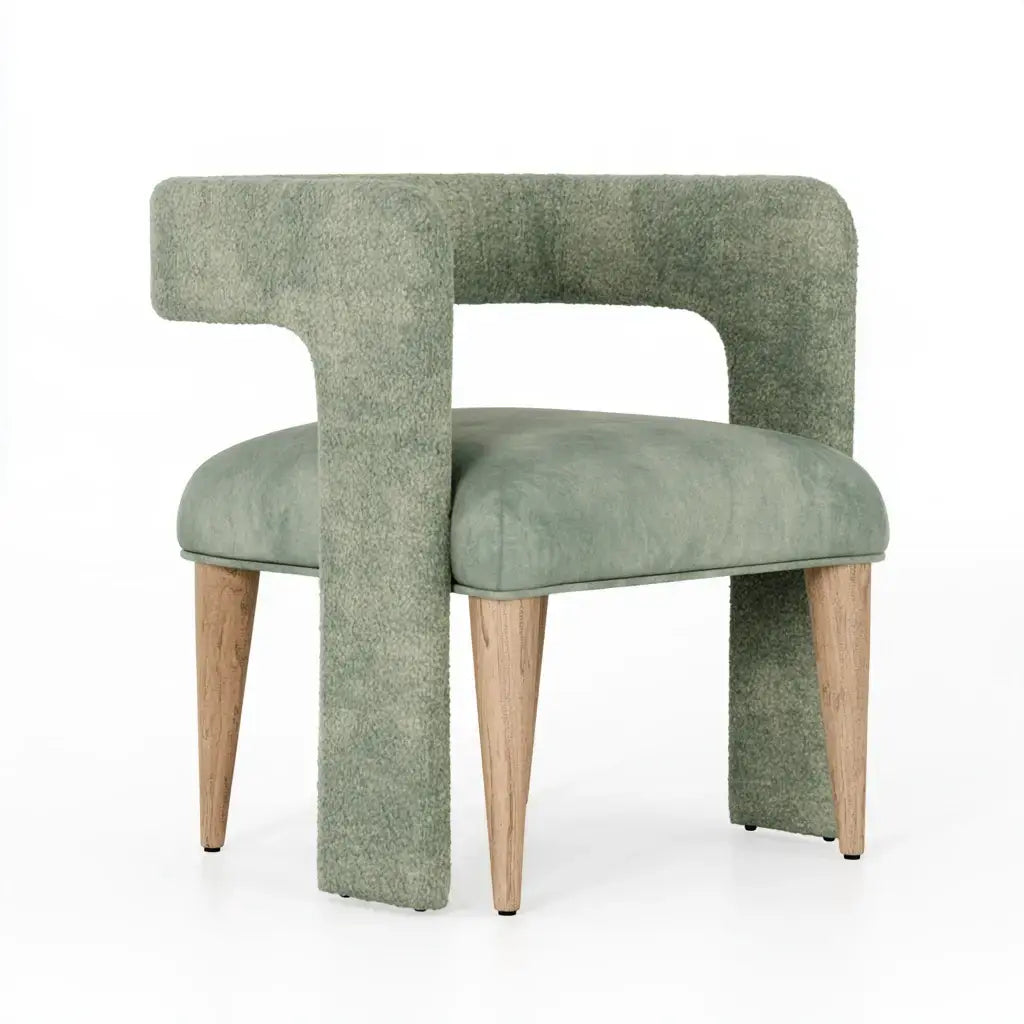 Green craftandcrux collection chair with open-backed design and upholstered frame, showcasing modern seating comfort.